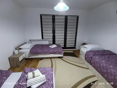 a room with two beds and a window at Apartment Happy Corner in Visoko