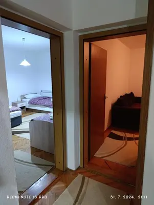 a room with a sliding glass door and a bedroom at Apartment Happy Corner in Visoko