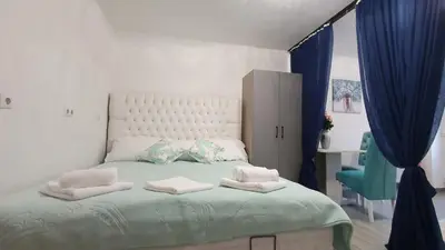 a bedroom with a bed with two pillows on it at Studio Apartman Mint Bihac in Bihać