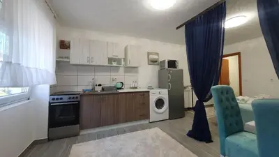 a kitchen with a refrigerator and a washing machine at Studio Apartman Mint Bihac in Bihać
