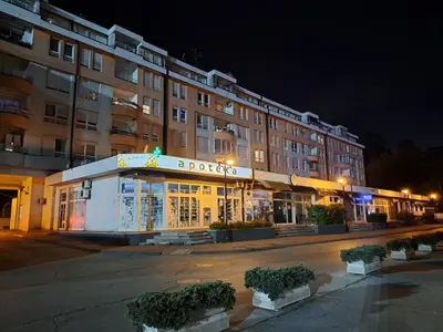 a building with a store in front of it at night at Premier Apartment in Banja Luka