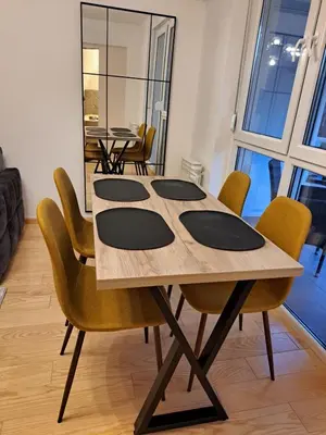 a dining room with a table and chairs at Premier Apartment in Banja Luka