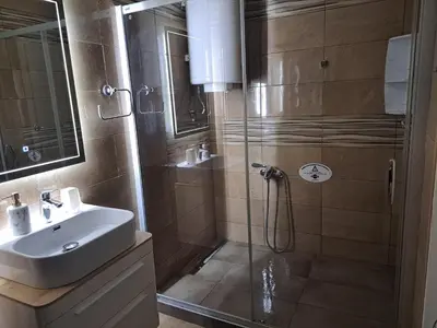 a bathroom with a shower and a sink at Premier Apartment in Banja Luka
