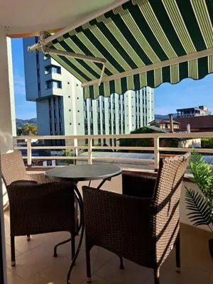 a patio with a table and chairs on a balcony at Premier Apartment in Banja Luka