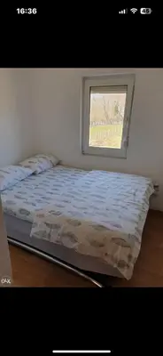 a bed in a room with a window at Hacijenda Simic in Krupa na Vrbasu