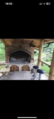 a stage with chairs and a stone wall at Hacijenda Simic in Krupa na Vrbasu