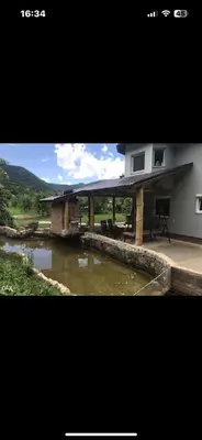 a picture of a house with a roof over a river at Hacijenda Simic in Krupa na Vrbasu