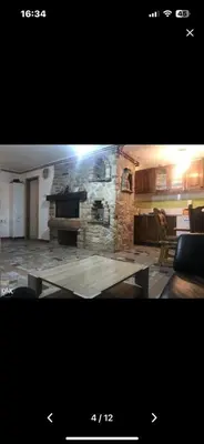 a picture of a living room with a stone fireplace at Hacijenda Simic in Krupa na Vrbasu