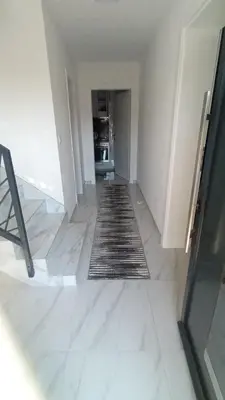 an empty hallway with a rug on the floor at 
