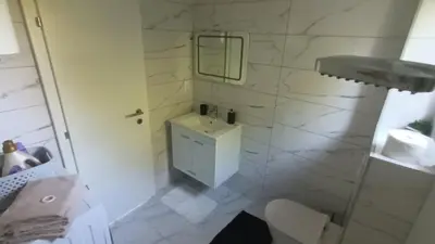 a white bathroom with a sink and a mirror at 