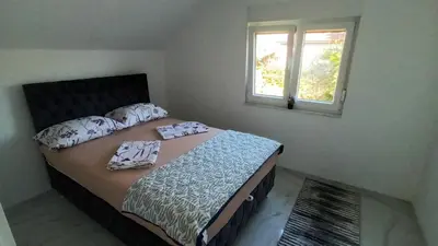a bedroom with a bed with pillows and a window at 