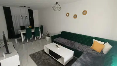 a living room with a green couch and a table at 