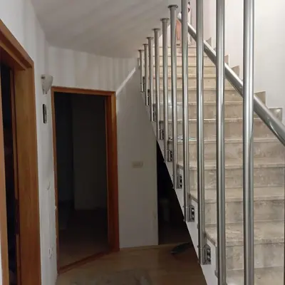 a staircase in a house with metal railing at Petra in Livno