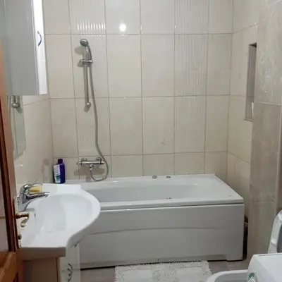 a bathroom with a bath tub and a sink at Petra in Livno