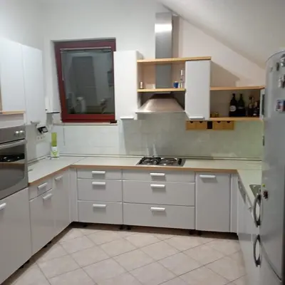 a kitchen with white cabinets and a stove in it at Petra in Livno