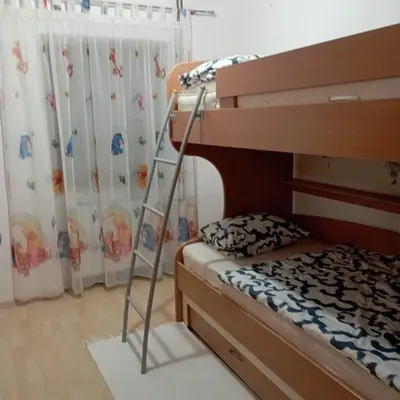 a bedroom with a bunk bed and a ladder at Petra in Livno