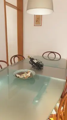 a glass table with a plate of food on it at Petra in Livno
