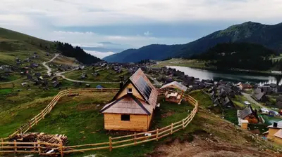 a small house on a hill next to a river at BellaVista Prokosko Jezero in Paljike
