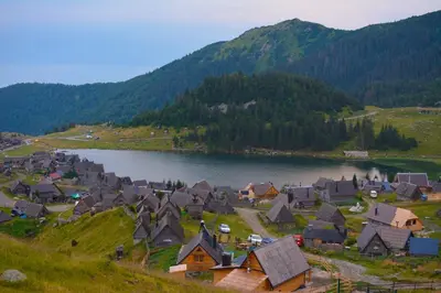 a village next to a lake with a mountain at BellaVista Prokosko Jezero in Paljike