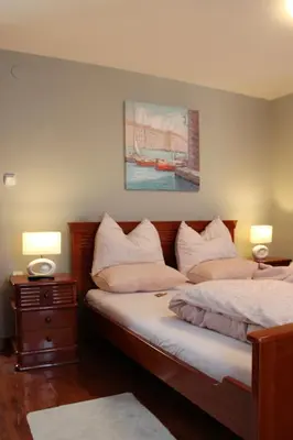 a bedroom with two beds and two lamps and a painting at Intermezzo Vuk in Banja Luka