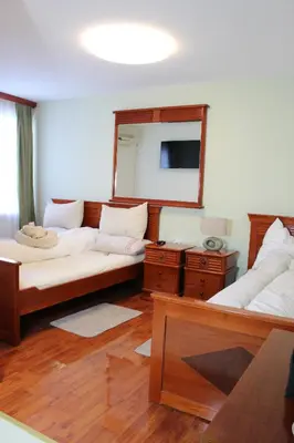 a living room with two beds and a mirror at Intermezzo Vuk in Banja Luka