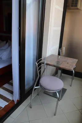 a table and a chair and a table and a bed at Intermezzo Vuk in Banja Luka