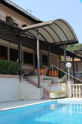 a house with a swimming pool in front of a building at Intermezzo Vuk in Banja Luka