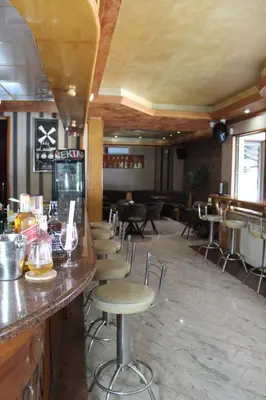 a bar in a restaurant with chairs and tables at Intermezzo Vuk in Banja Luka
