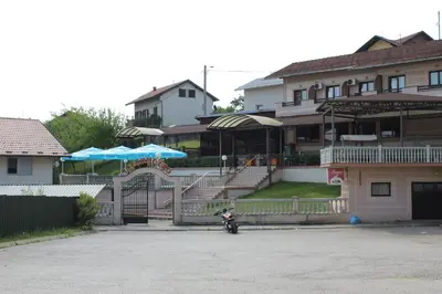 a motorcycle parked in a parking lot in front of a building at Intermezzo Vuk in Banja Luka