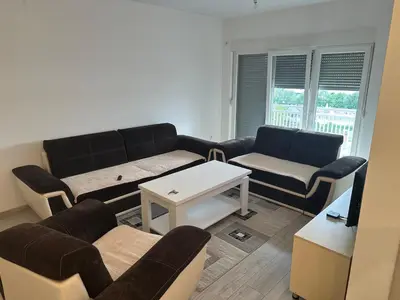 a living room with a couch and a table at Stan Živinice in Živinice
