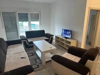 a living room with a couch and a table at Stan Živinice in Živinice