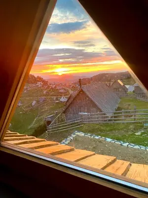 a view of a sunset from a window at BellaVista Srce Prokosko Jezero in Fojnica