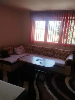 a living room with a couch and a coffee table at Apartment Miki in Visoko