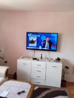 a living room with a flat screen tv on a wall at Apartment Miki in Visoko