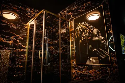 a bathroom with a picture of a head on the wall at Spa centar LUX Doboj in Doboj