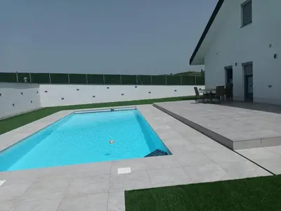 a swimming pool in the middle of a yard at Vila Pascha in Zlopoljac