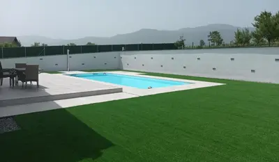 a backyard with a pool and green grass at Vila Pascha in Zlopoljac