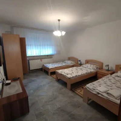a room with three beds and a window at Prenoćiste Borik in Sanski most