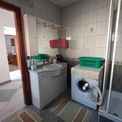 a bathroom with a washing machine and a sink at Prenoćiste Borik in Sanski most