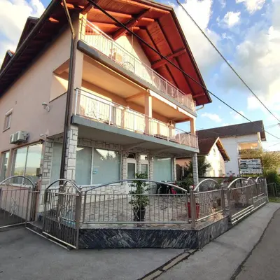 a house with a balcony on the side of it at Prenoćište BORIK in Sanski most