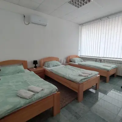 a bedroom with two beds and a window at Prenoćište BORIK in Sanski most