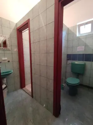 a bathroom with a green toilet and a sink at Prenoćište BORIK in Sanski most