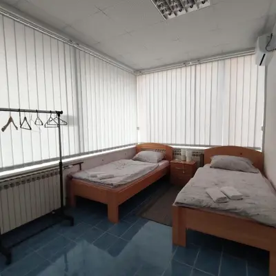 two beds sitting in a room with windows at Prenoćište BORIK in Sanski most