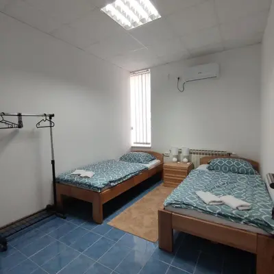 a room with two beds and a window at Prenoćište BORIK in Sanski most
