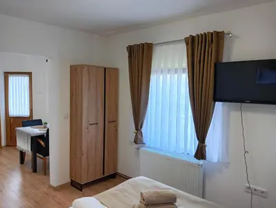 a bedroom with a bed and a window and a desk at Villa Medo in Kulen Vakuf