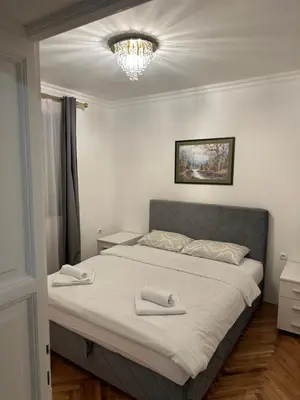 a bedroom with a bed with two towels on it at Royal Apartment in Banja Luka