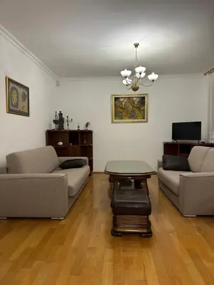 a living room with two couches and a table at Royal Apartment in Banja Luka