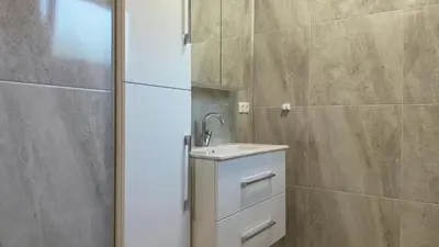 a bathroom with a sink and a shower at Apartments Bioland in Kulen Vakuf