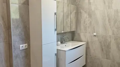 a bathroom with a sink and a mirror at Apartments Bioland in Kulen Vakuf