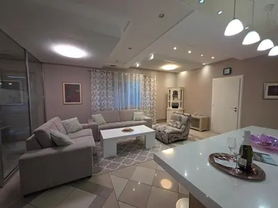 a living room with a couch and a table at Apartmani EMA Bihać in Bihać